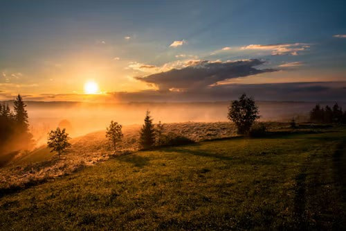 Misty sunrise over green hills, waking up clear after a low dose of melatonin